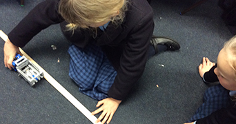 Two children doing a floorbook