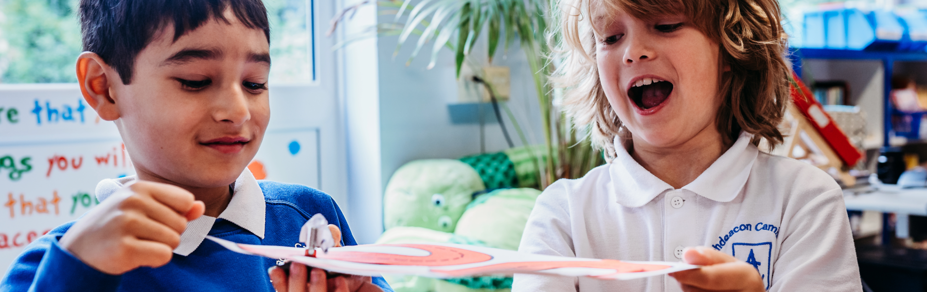 two primary children exploring magnets in the primary classroom