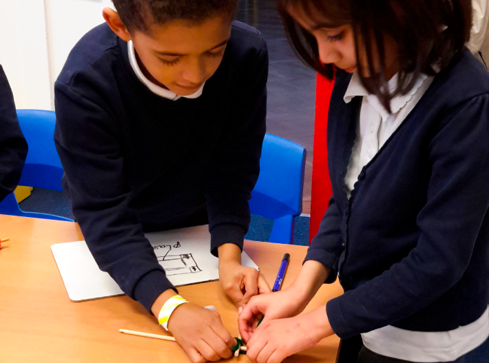 Two primary school children working together on a practical science investigation